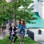 young-tourist-couple-travellers-with-electric-scooters-in-small-town-768x503
